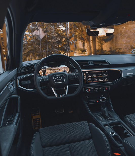 Modern Audi Q3 interior view showcasing the luxurious cabin space, advanced MMI infotainment system, and elegant dashboard design.